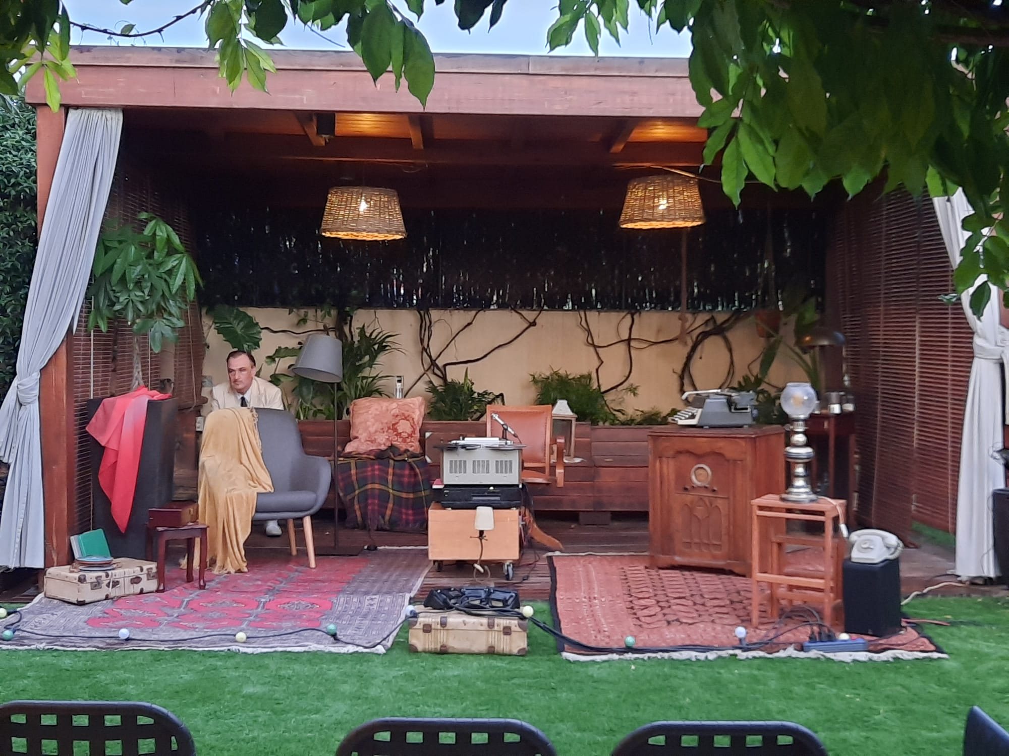 Porxo de jardí convertit en escenari amb mobles i catifes